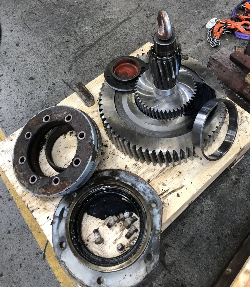 Opened gearbox components on a workshop floor