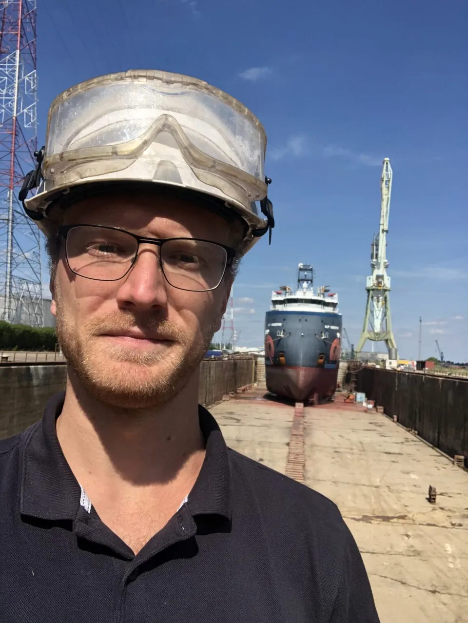 Bert Timmers in front of a ship in dry dock